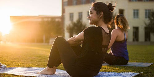 female ucf students practicing yoga on memory mall