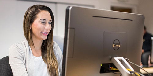 female ucf student working on computer