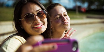 Two girls tweeting a selfie