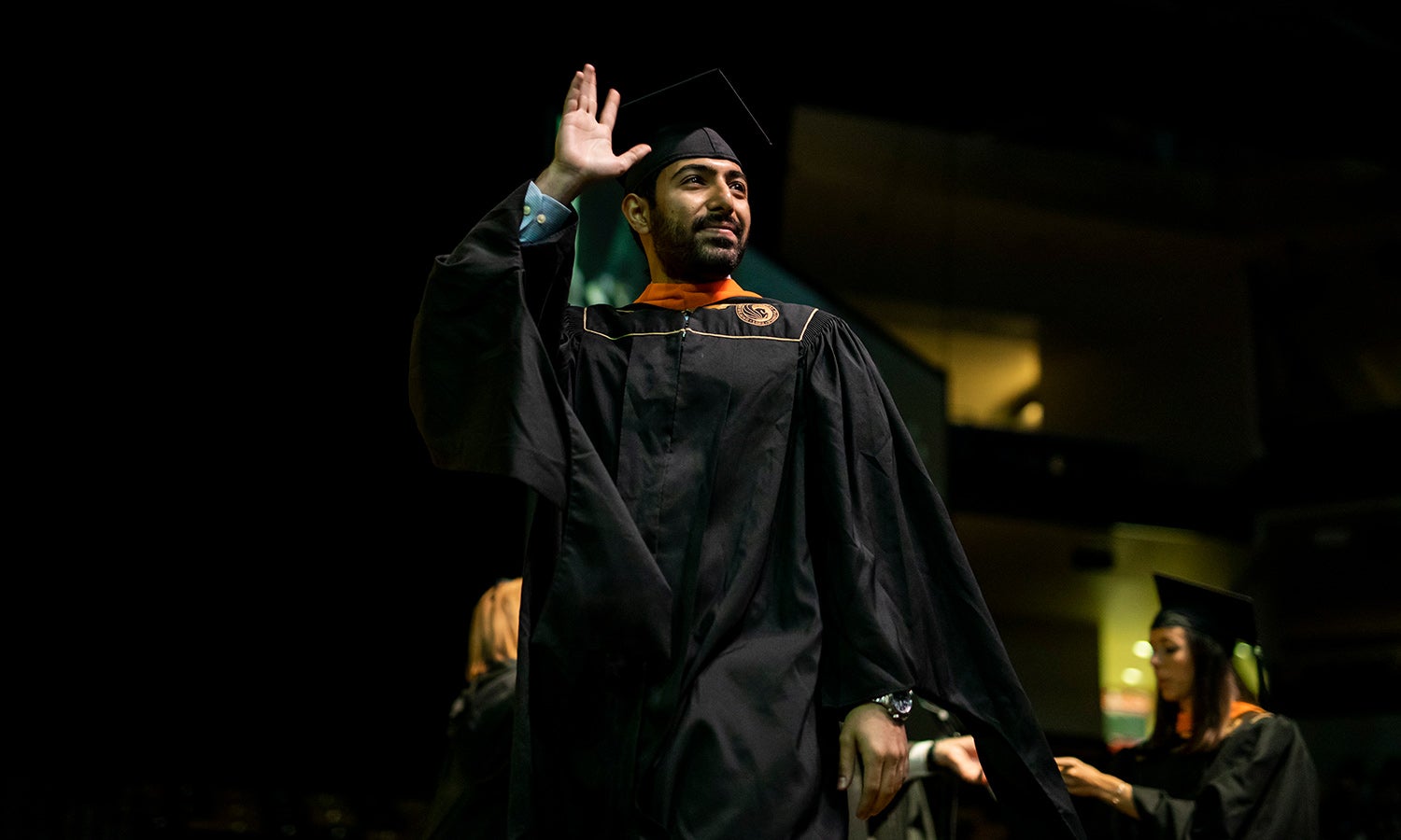 Successful student crosses the stage at graduation.