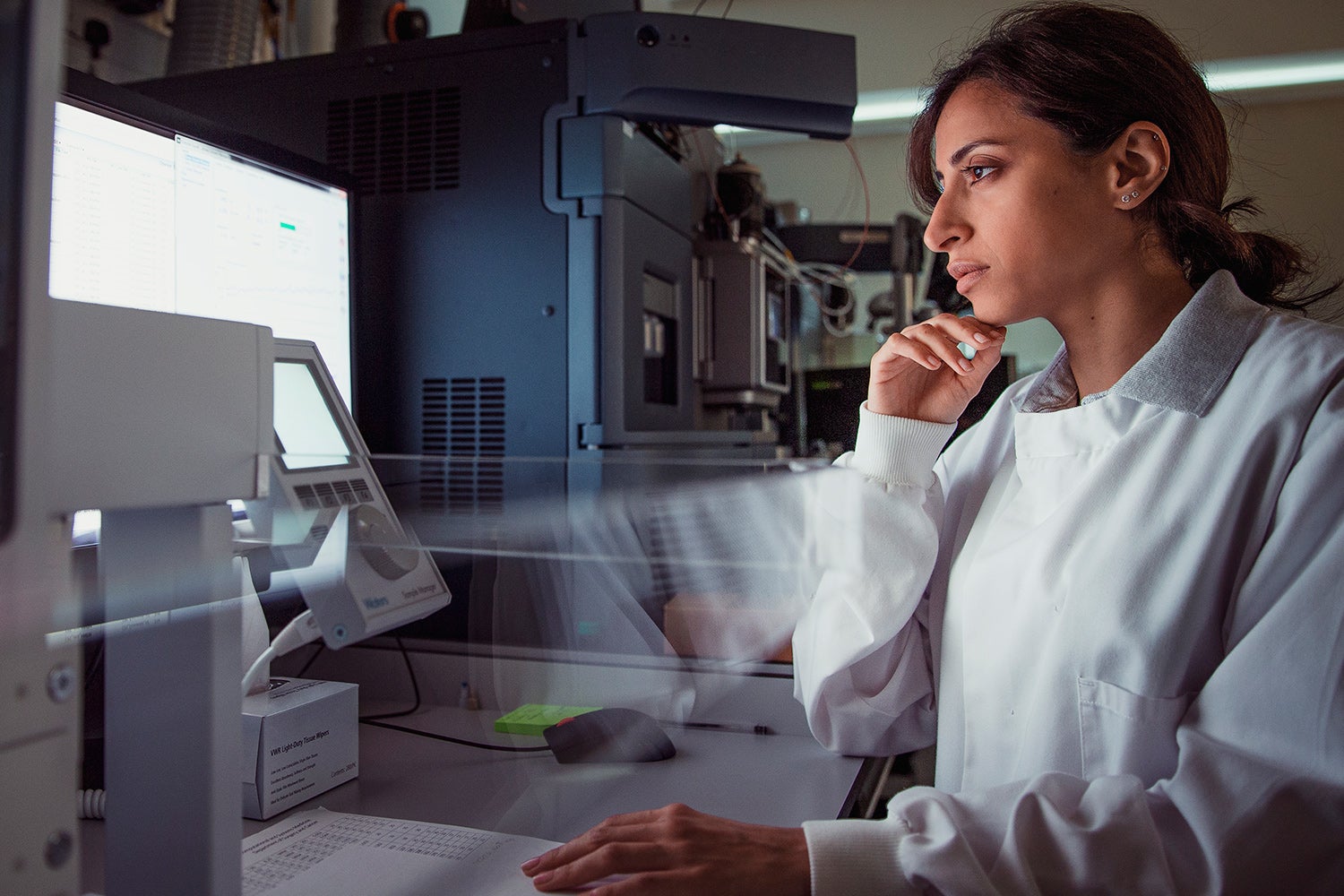 Forensic Scientist staring at data.