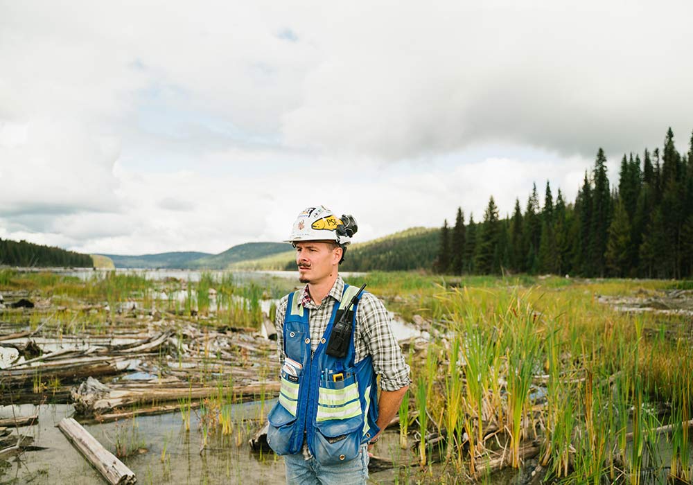 Environmental Engineer stands in a swamp.