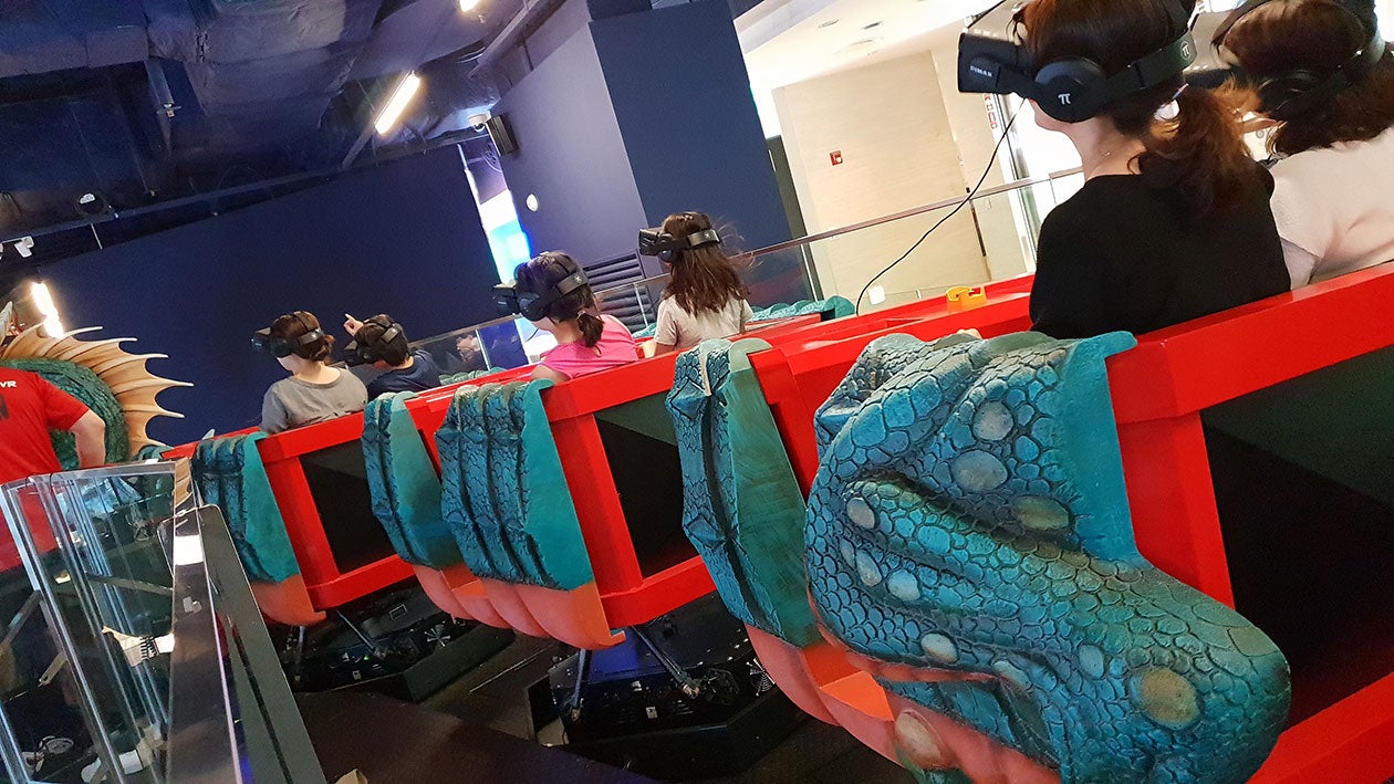 People wearing VR headsets on the Lotte Monster VR ride