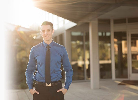 Student standing in front of building