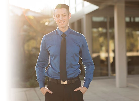 Student standing in front of building