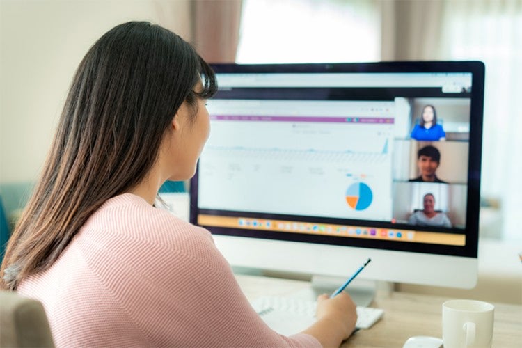 A manager meets with her team online.