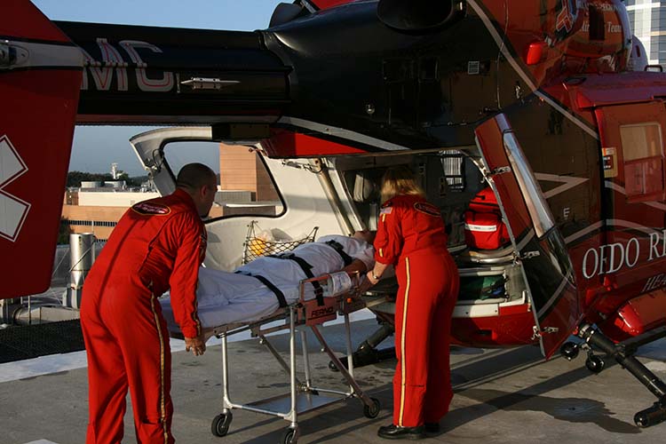 EMTs load a patient on a helicopter