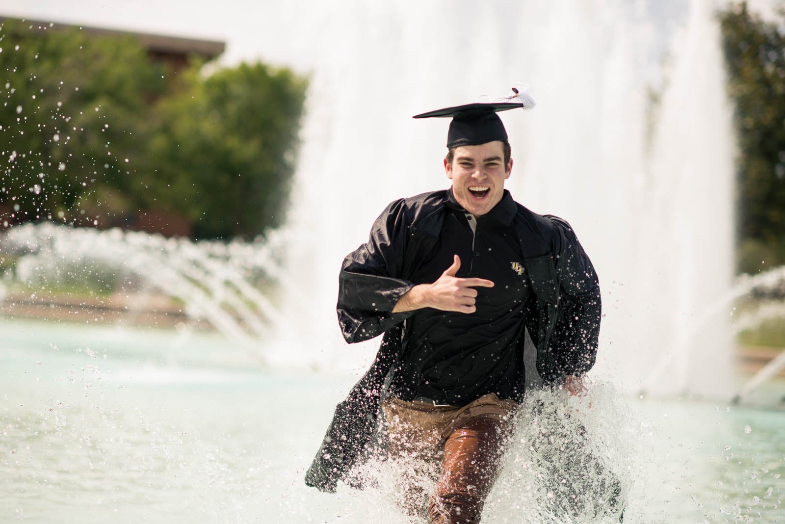 ucf-best-of-photos-graduate-running-through-reflecting-pond ucf-best-of-photos-graduate-running-through-reflecting-pond