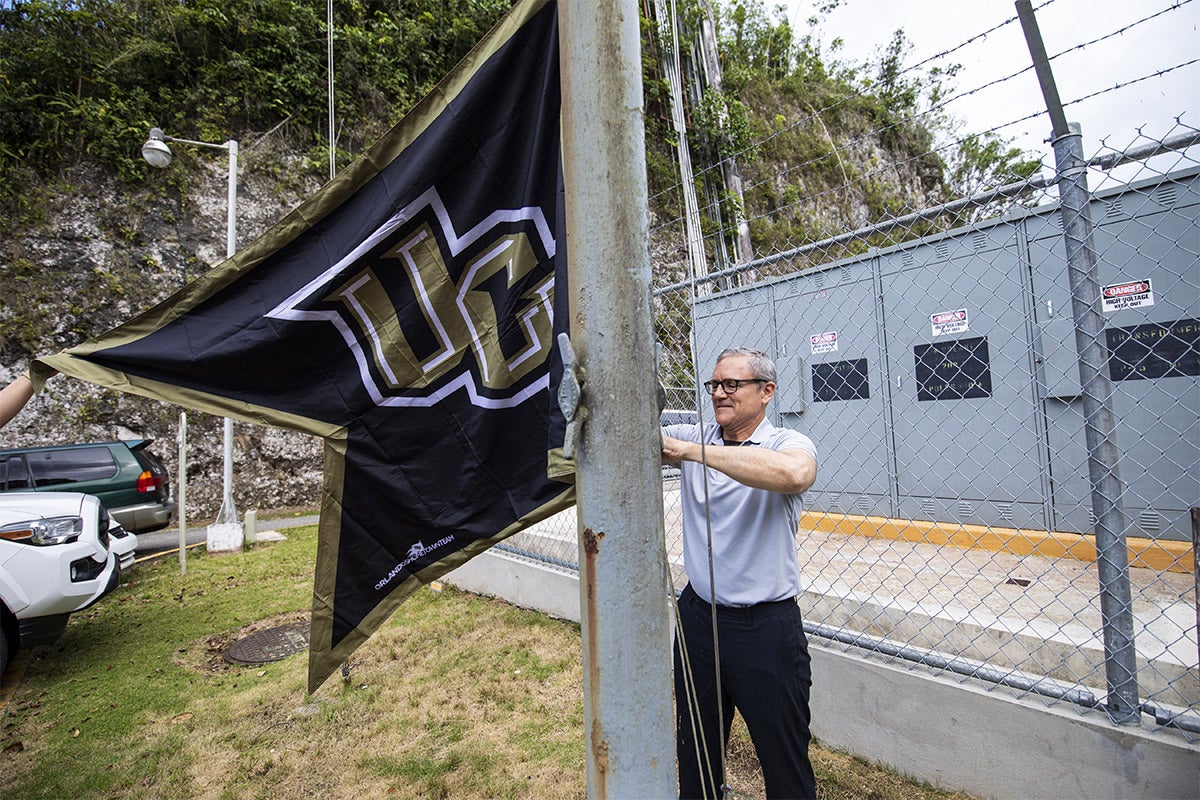 President Dale Whittaker putting up ucf flag at Arecibo. President Dale Whittaker putting up ucf flag at Arecibo.