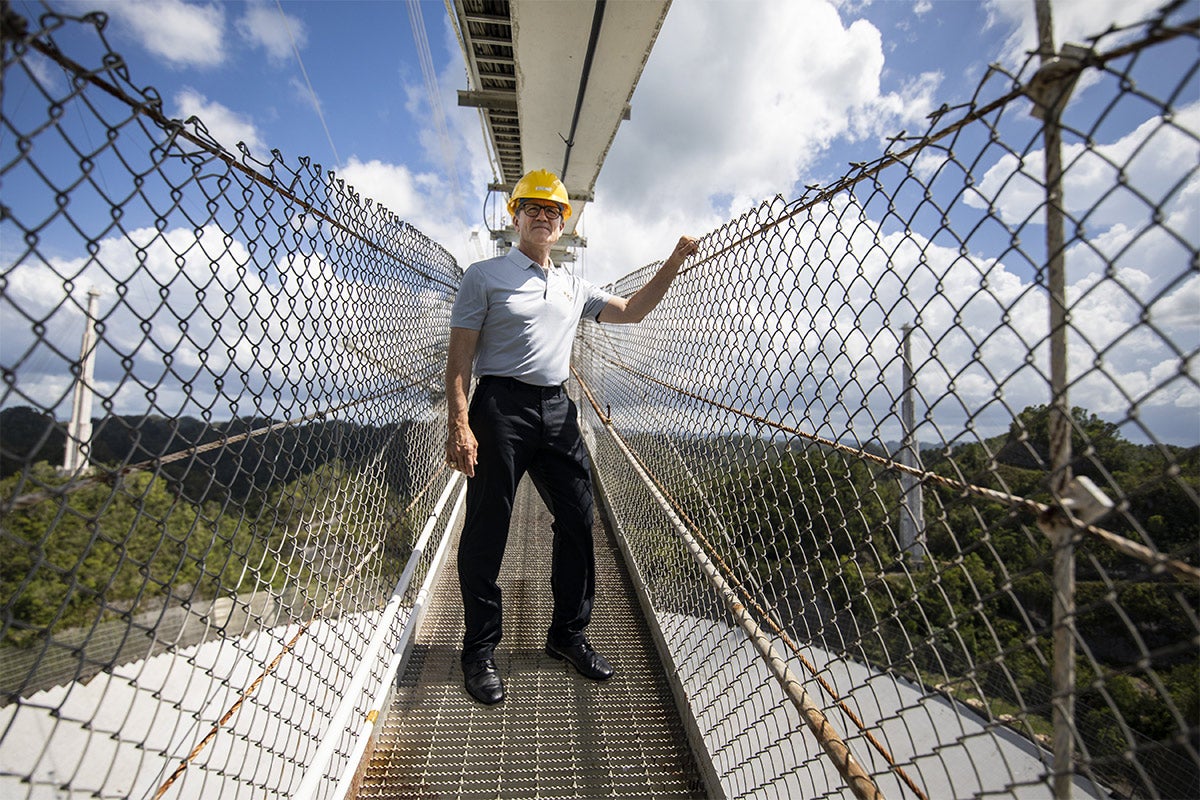 President Dale Whittaker standing on a suspension bridge over Arecibo. President Dale Whittaker standing on a suspension bridge over Arecibo.