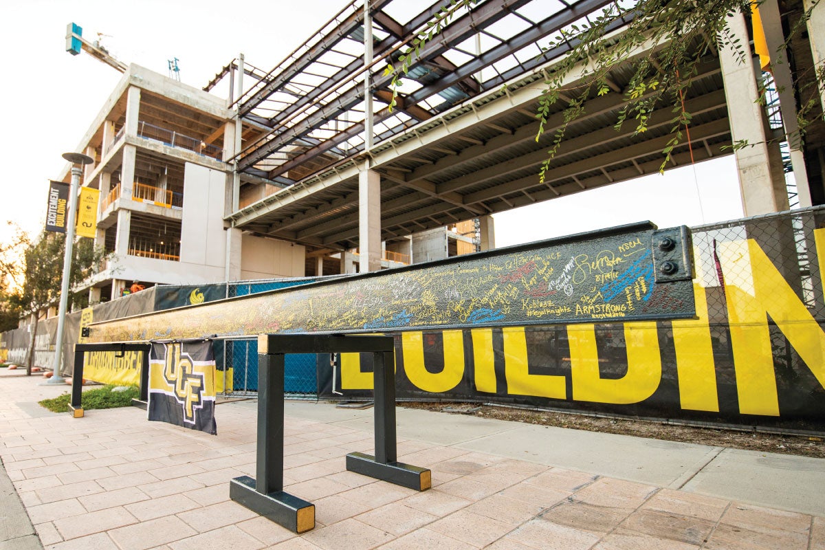 A steel beam outside the UCF Downtown campus is covered with signatures.