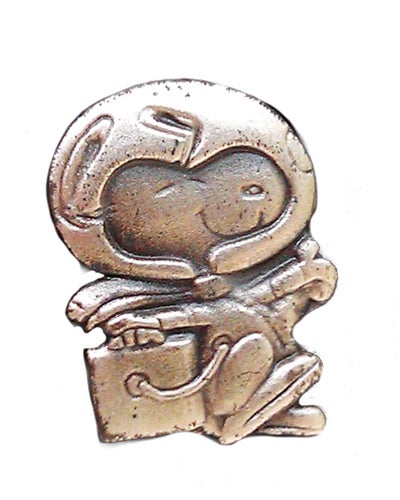 A silver Snoopy pin