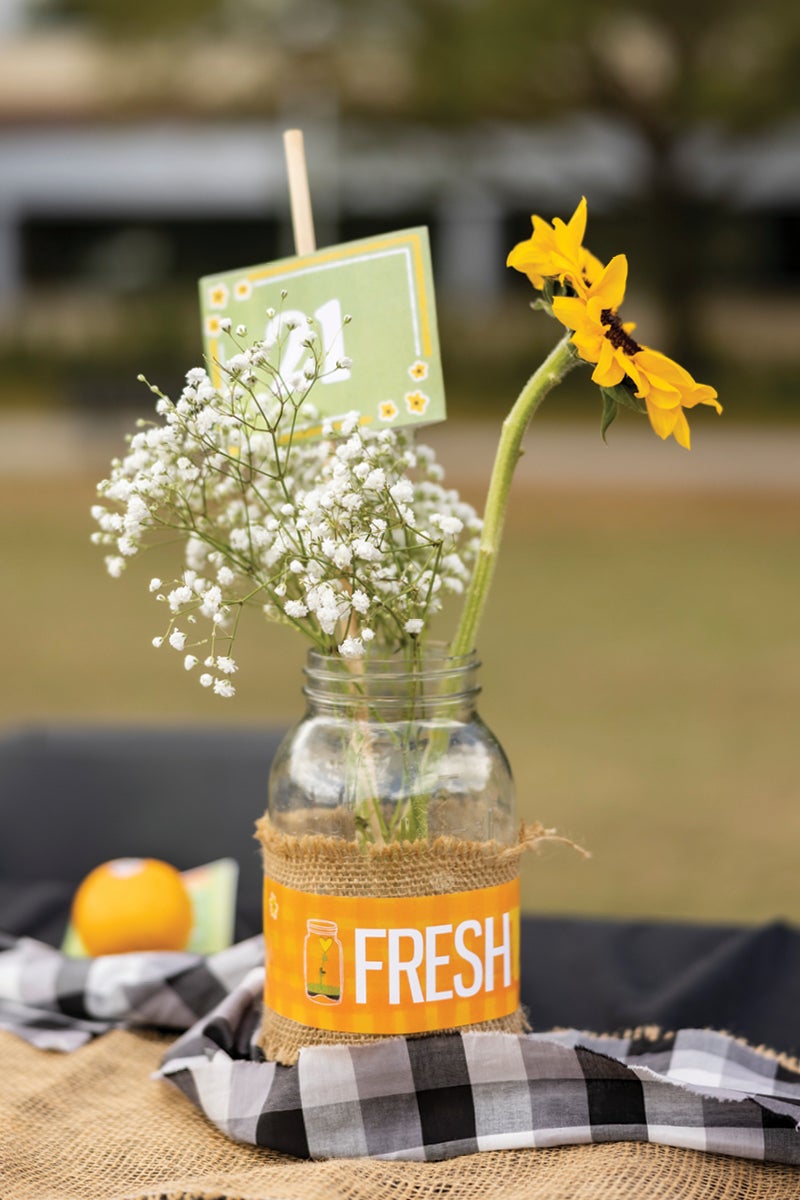 A jar filled with flowers on a table.
