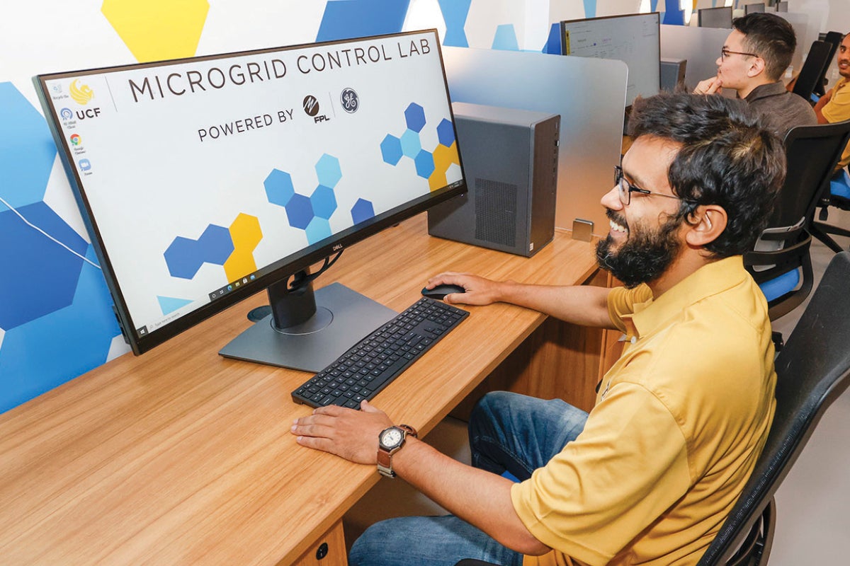 A student uses a computer in the UCF Microgrid Control Lab.
