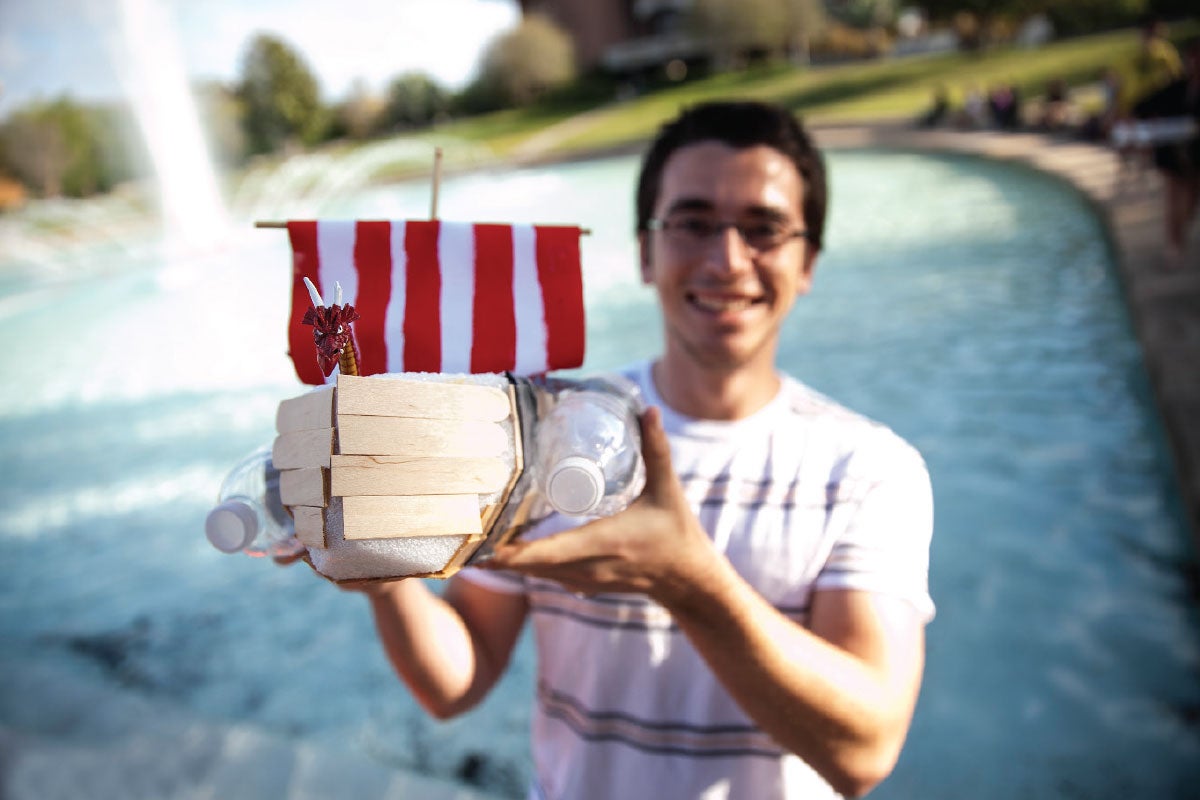 Student showing off his watercraft in front of the UCF reflecting pond.