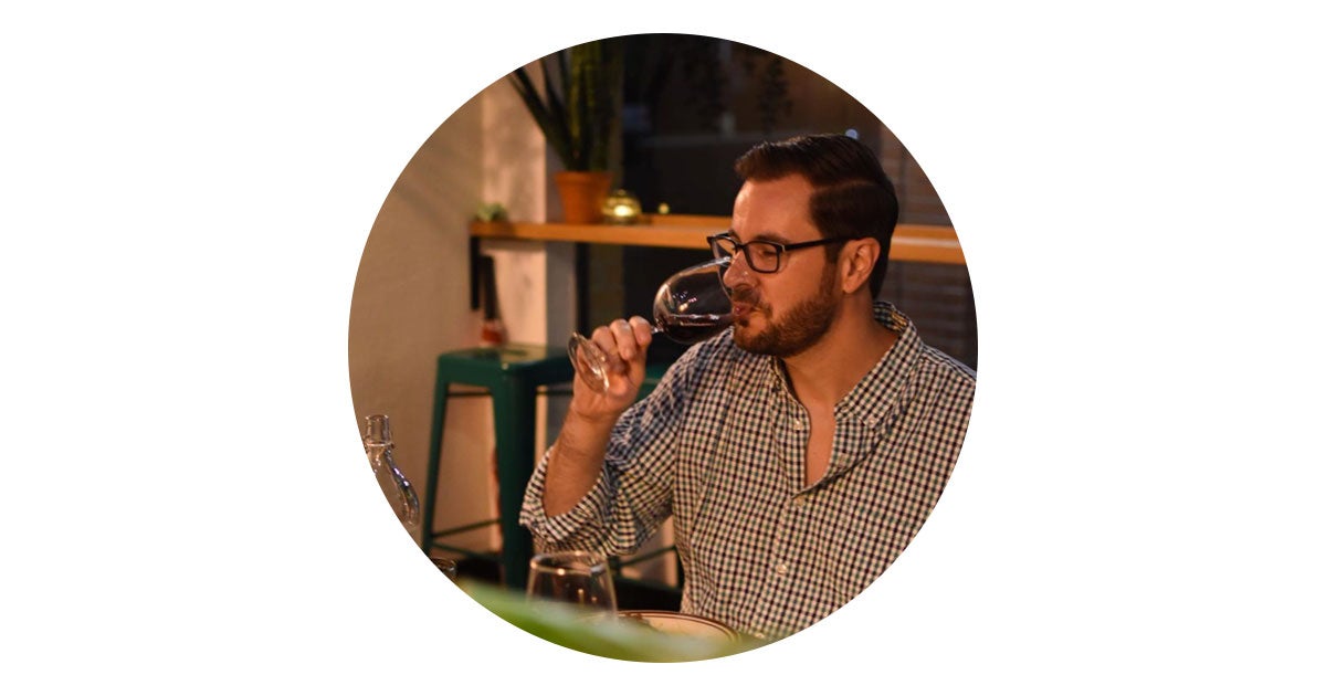 A photo of a man drinking wine