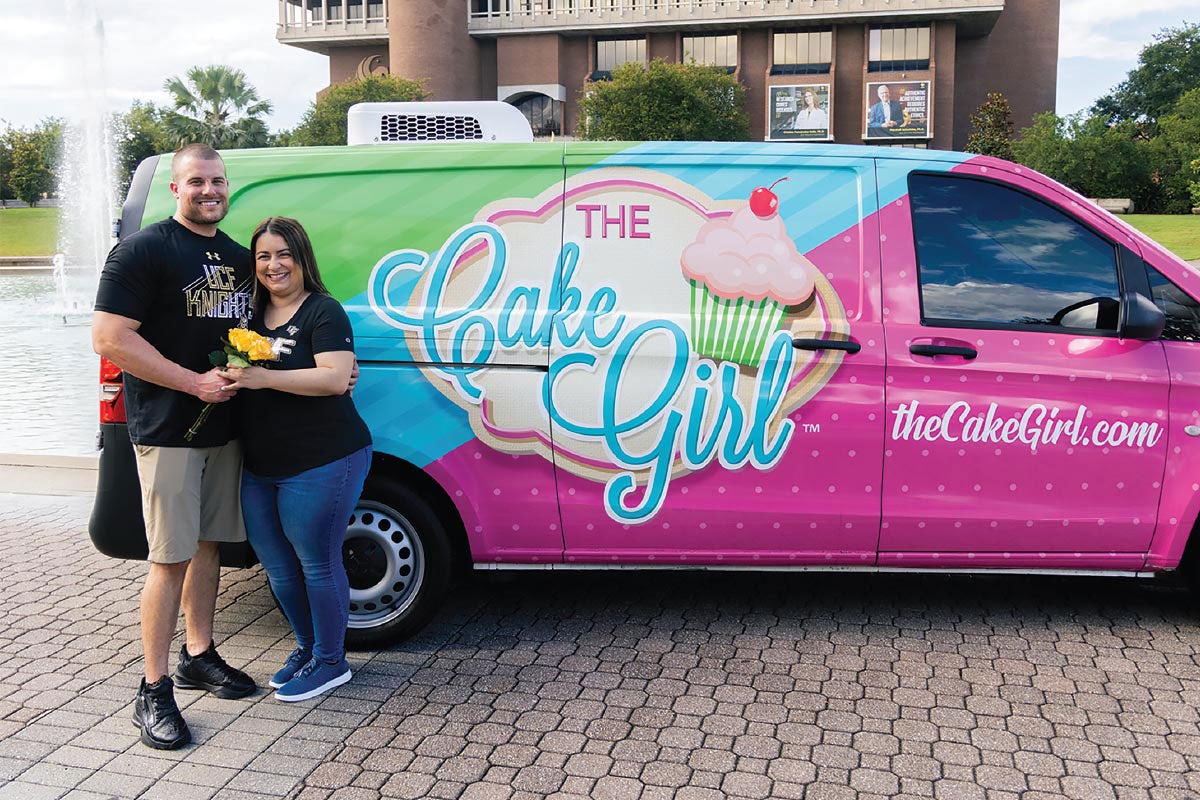 Kirby and Kristina Lavellee pose in front of their The Cake Girl van by the Reflecting Pond.