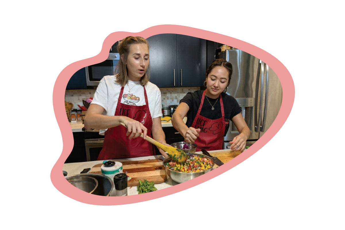 A photo of two people cooking