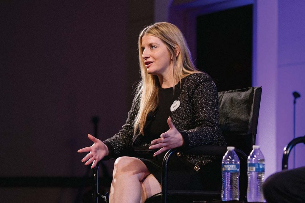 A woman wearing a suit and speaking