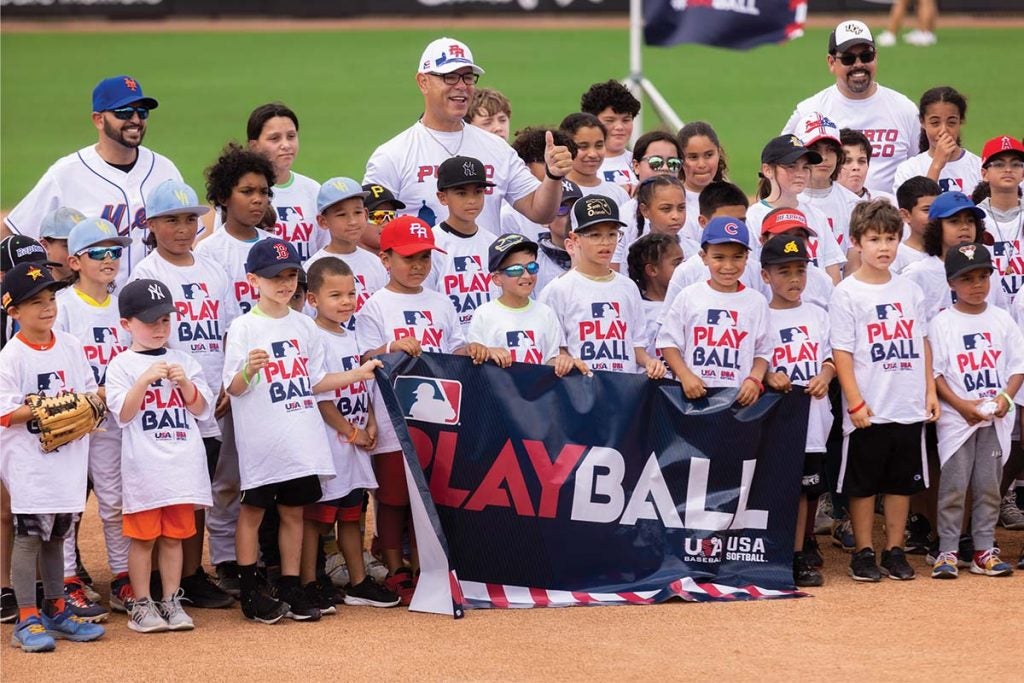 A group of students posing for a photo with former MLB players and UCF Professor Fernando Rivera