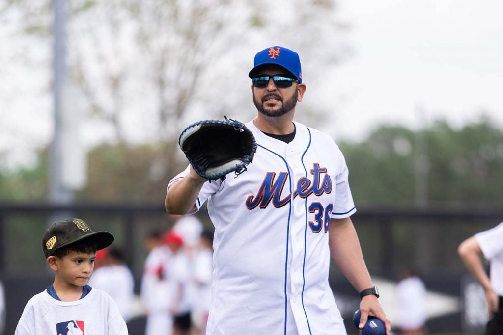 Former MLB player Willie Collazo from the New York Mets holds a catcher's mitt.