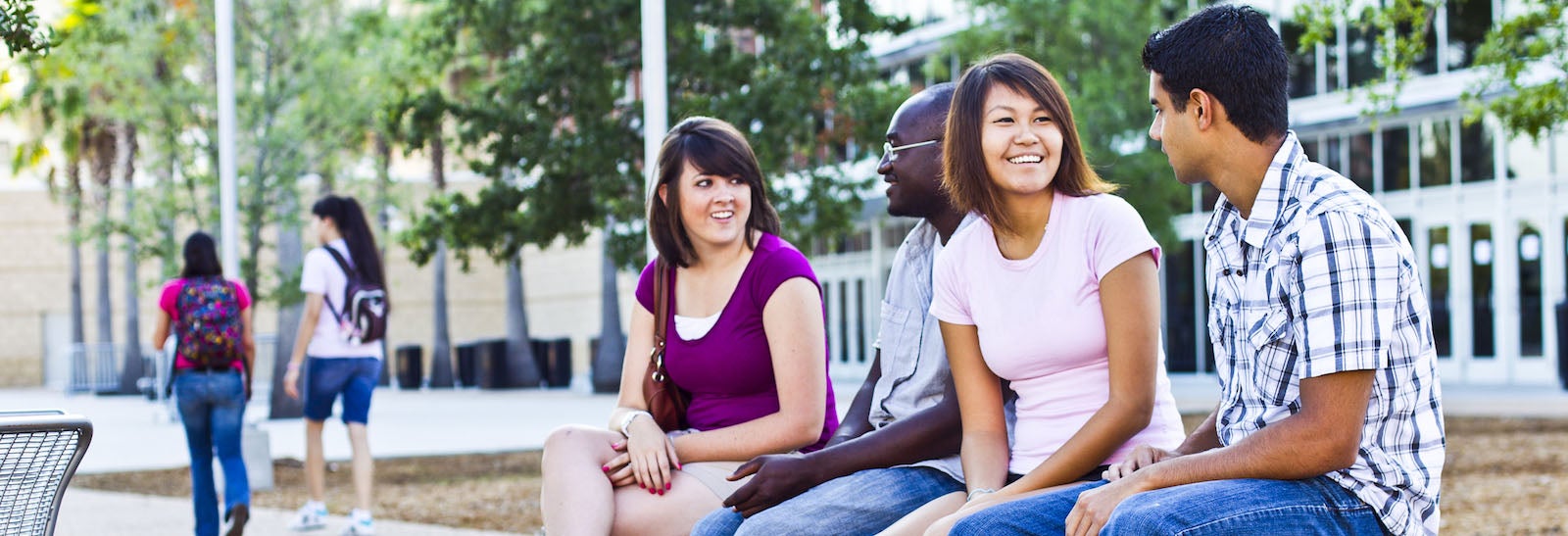 ucf students sitting on bench while chatting