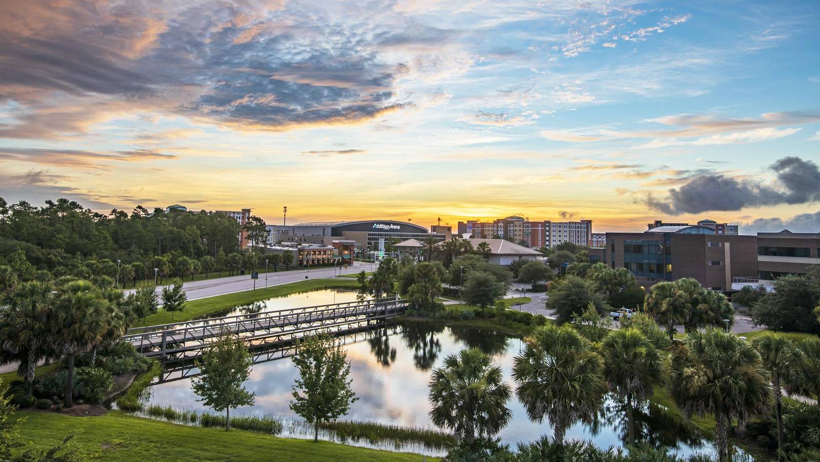 Sun rises across the main campus with the arena in the background.