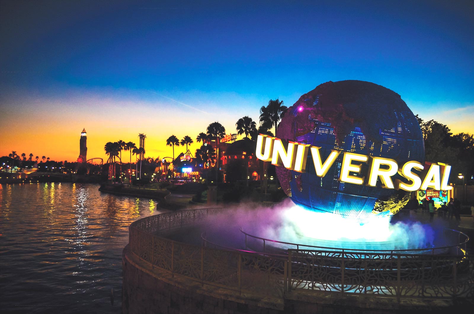 The sun sets near an entrance of Universal Studios