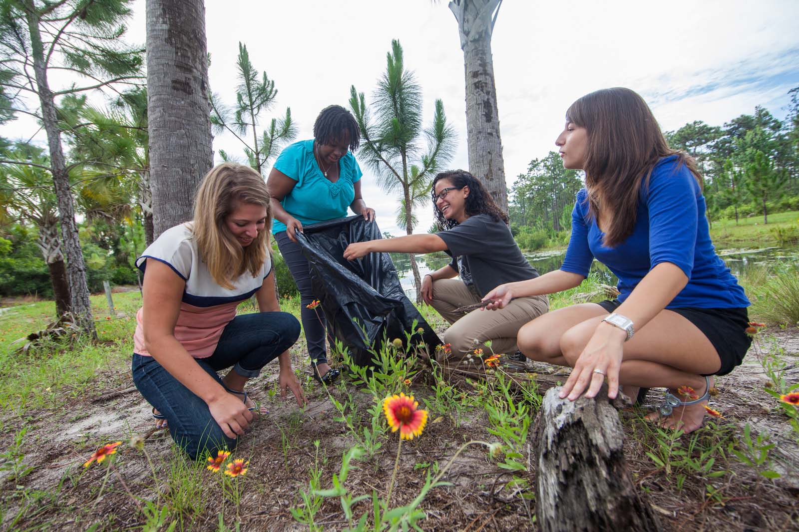 Students clean up and take care of plants around the UCF Arboretum.