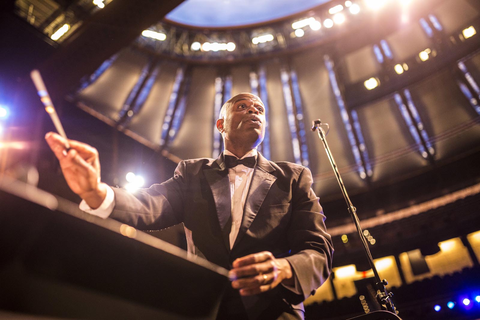 Music conductor with baton directing 