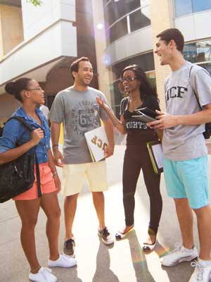 group of ucf students talking outside of a building between classes