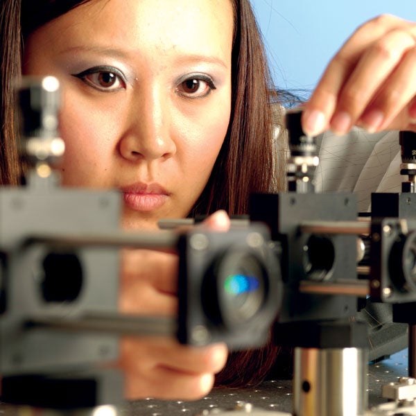 closeup of female's face while working intensely in optics and photonics lab