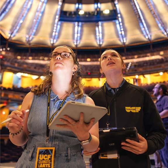 UCF students preparing for a performance inside a theater.