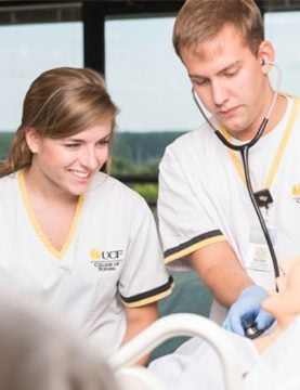 UCF nursing students learning how to read a patient's heartbeat