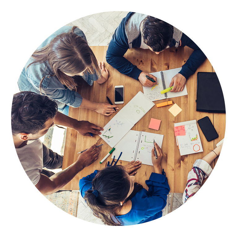 People working at a tabletop together on plans for an event