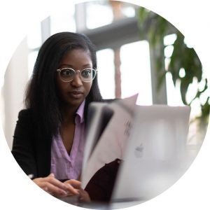 Business analyst working a computer reviewing data