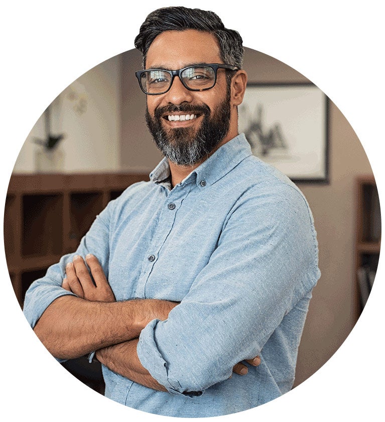 Male with glasses smiling at camera