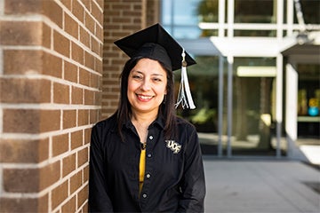 Sonia Cox posing with graduation cap on