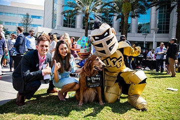 Knightro posing with students on UCF College of Medicine Match Day