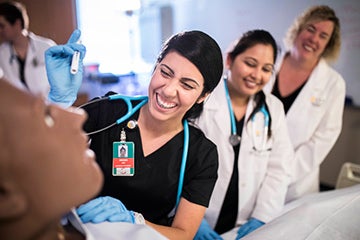 UCF Nursing students performing checkup on a patient simulator