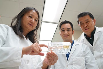 UCF researchers in lab looking at test samples