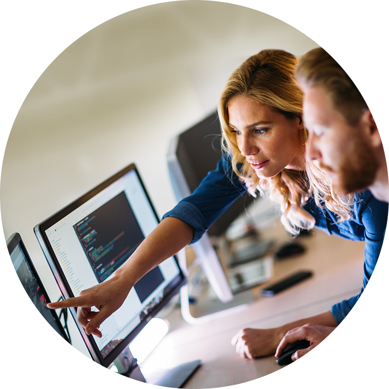 Two people working on computer.