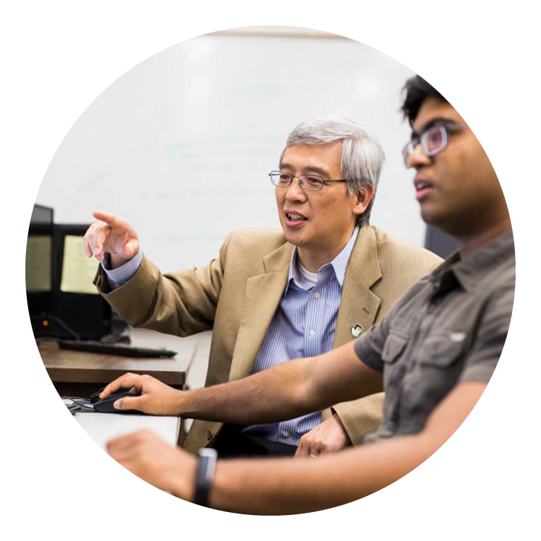 Professor working with student on computer