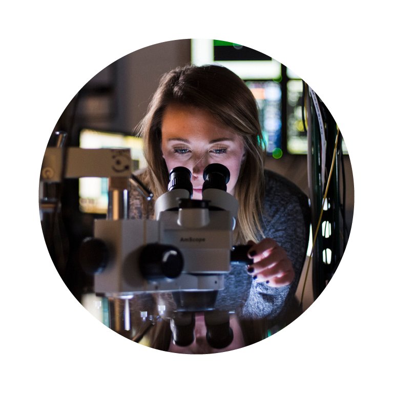 Female looking into microscope