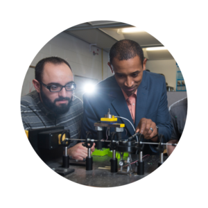 Professor helping students with mechanical engineering project