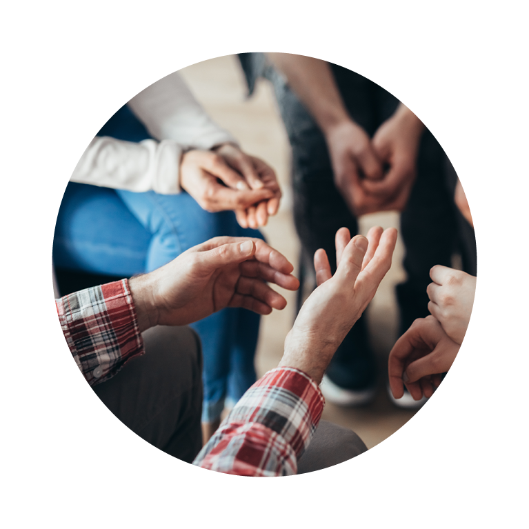 Image of hands while sitting in a round table discussion