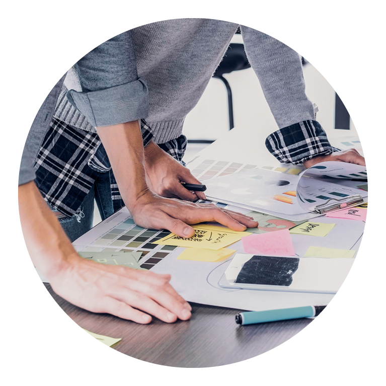 Two people working together at table looking over notes and documents