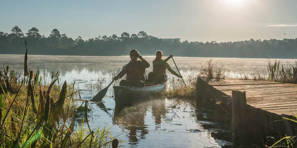 Two students in a canoe around Lake Claire
