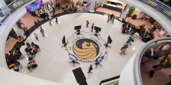 An overhead shot of the seal in the Student Union with students walking around