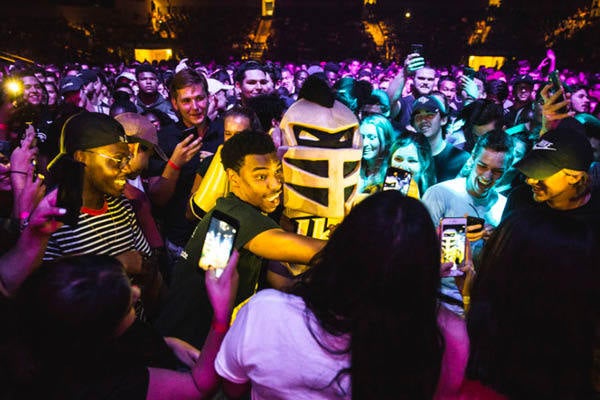 Student hugging Knightro and taking a photo at Pegasus Palooza